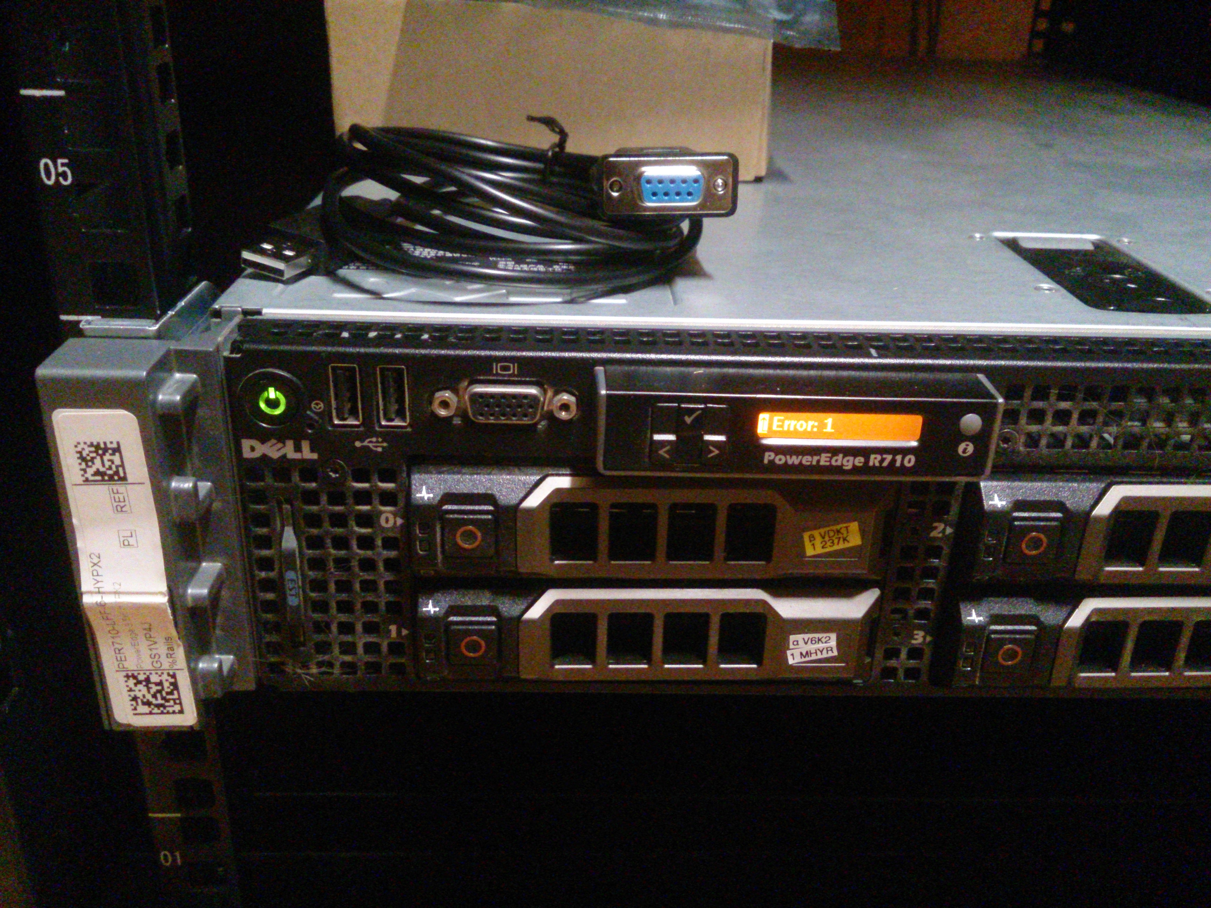 Front of the R710; visible are the power switch, two USB holes, VGA, and the status LCD