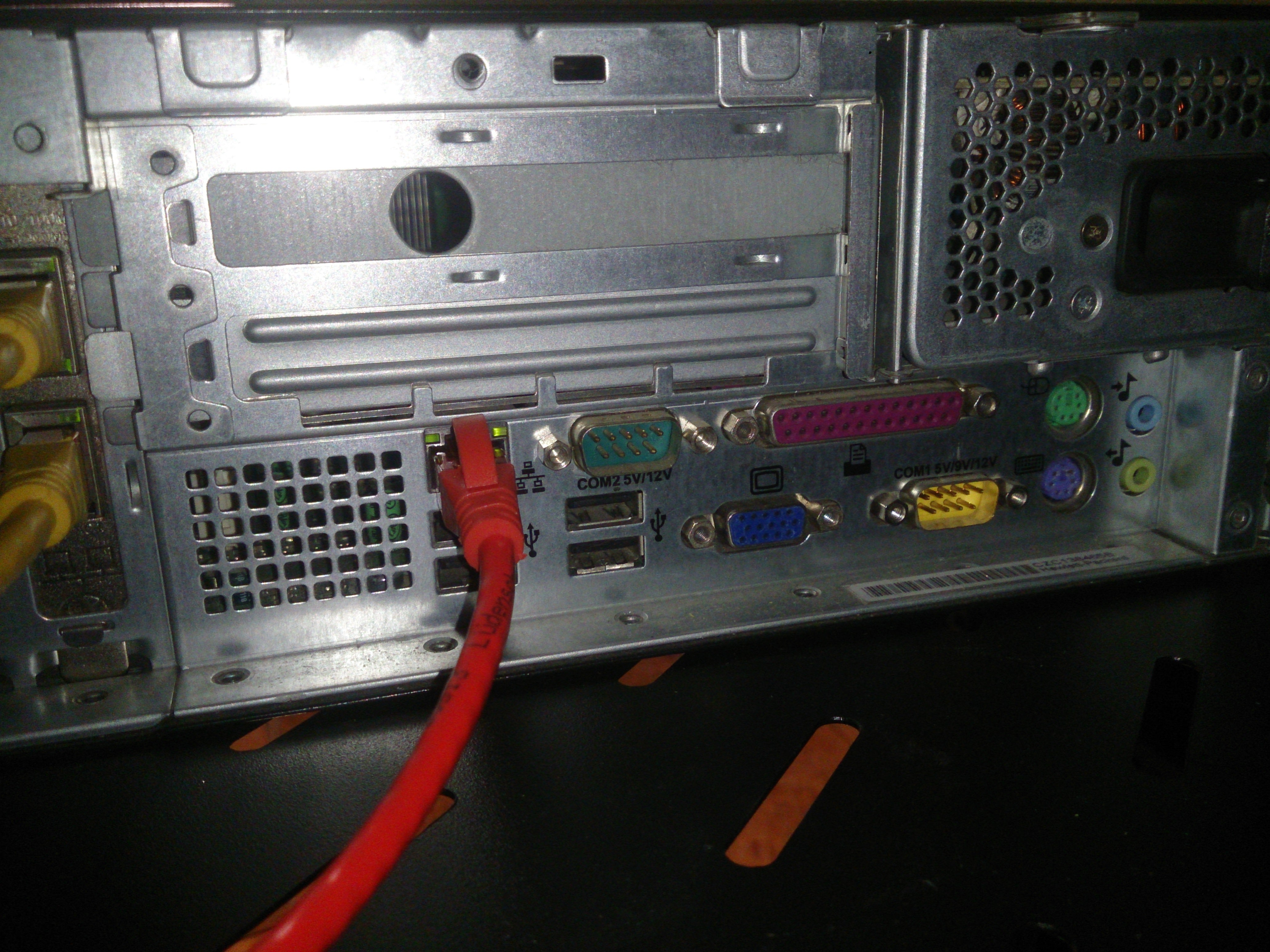 Back of the rp5700; visible are some ethernet cables, miscellaneous expansion ports, and chief among them two DB9 RS232s, labeled COM1 5V/9V/12V and COM2 5V/12V
